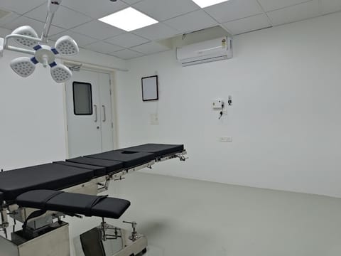 Modern operating theatre with surgical table and LED light at Osteon Orthopedic Hospital, Pimple Saudagar