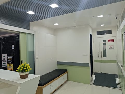Patient waiting area and corridor leading to OT complex and pharmacy at Osteon Orthopedic Hospital