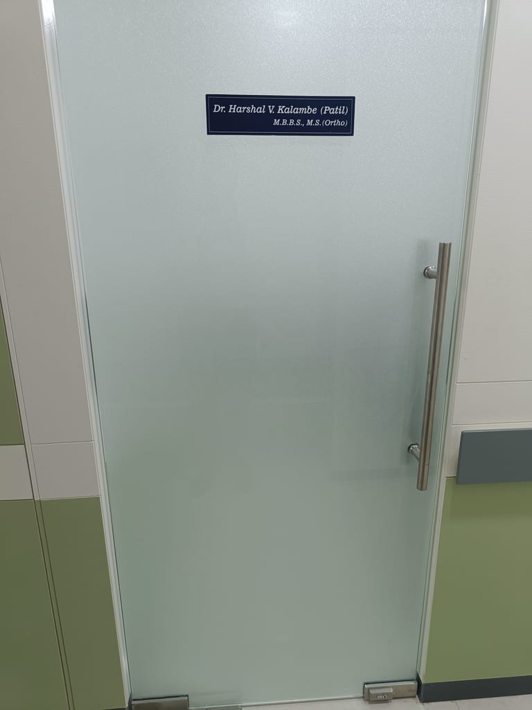 Glass door to Dr. Harshal V Kalambe Patil's consultation room at Osteon Orthopedic Hospital, MBBS, MS Ortho