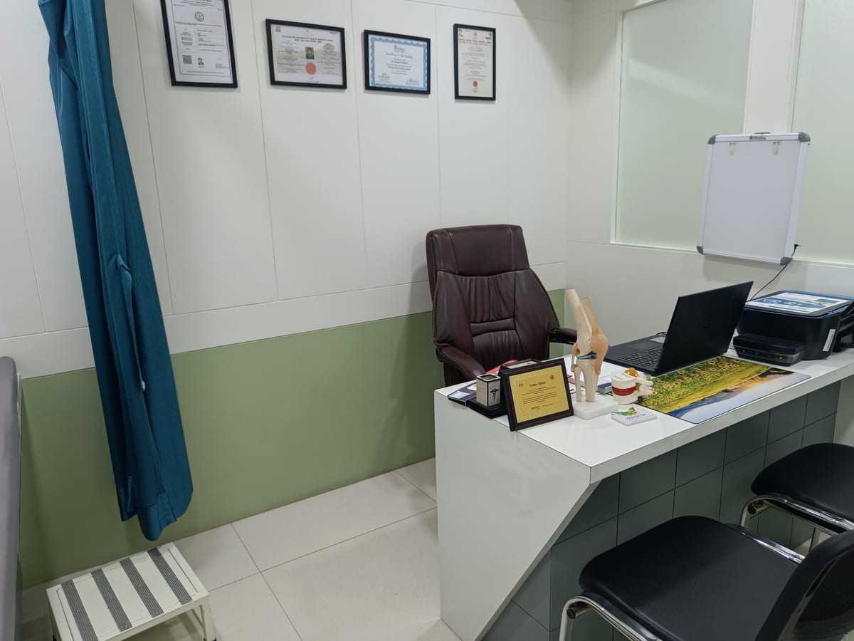Doctor's consultation room with framed certificates and orthopedic models at Osteon Orthopedic Hospital