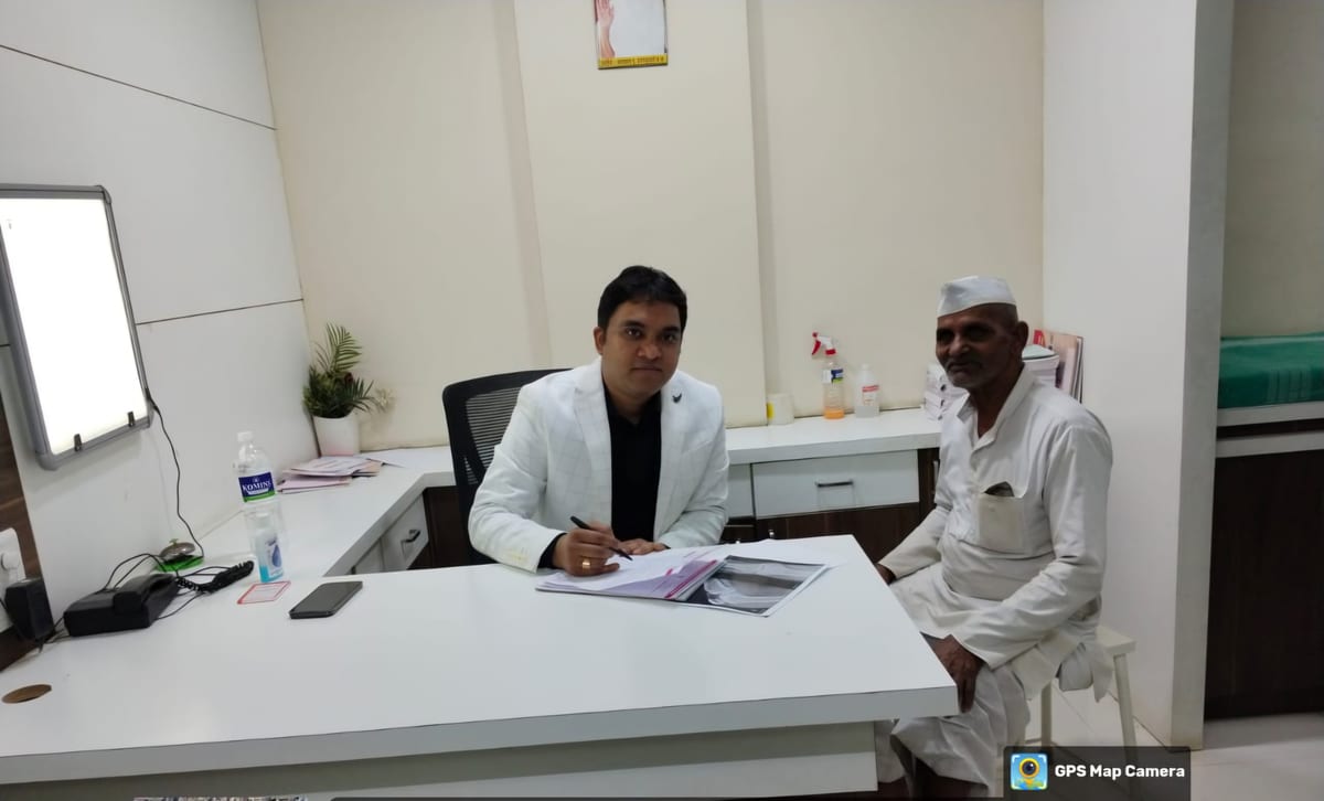 Dr. Harshal V Kalambe Patil consulting an elderly patient at Osteon Orthopedic Hospital consultation room in Pimple Saudagar